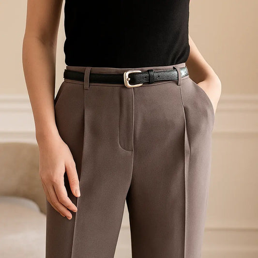 cinturón estrecho negro en uso sobre pantalón de mujer de cintura alta